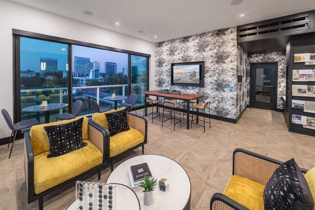 Resident lounge with chairs, table, and television