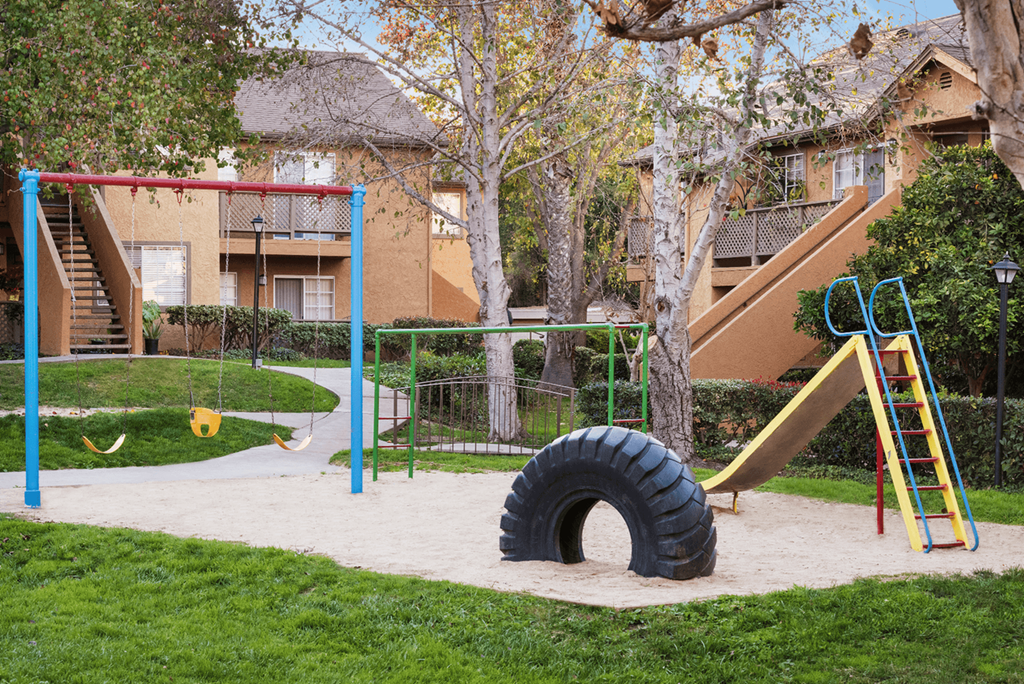 a playground with a slide and a tunnel