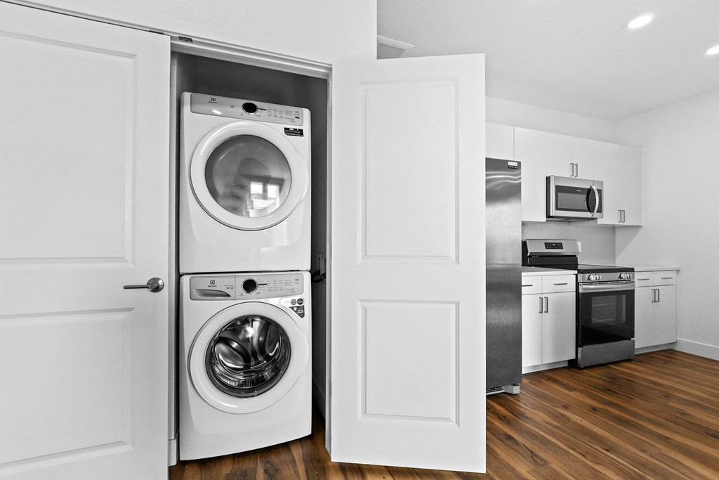 a white laundry room with a washer and a dryer