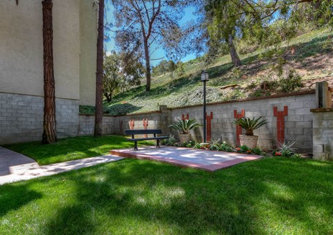 a backyard with a table and a fire pit