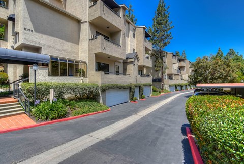an empty street in front of an apartment building