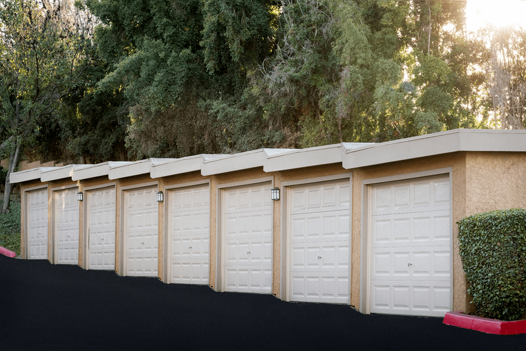 a row of garages with white doors