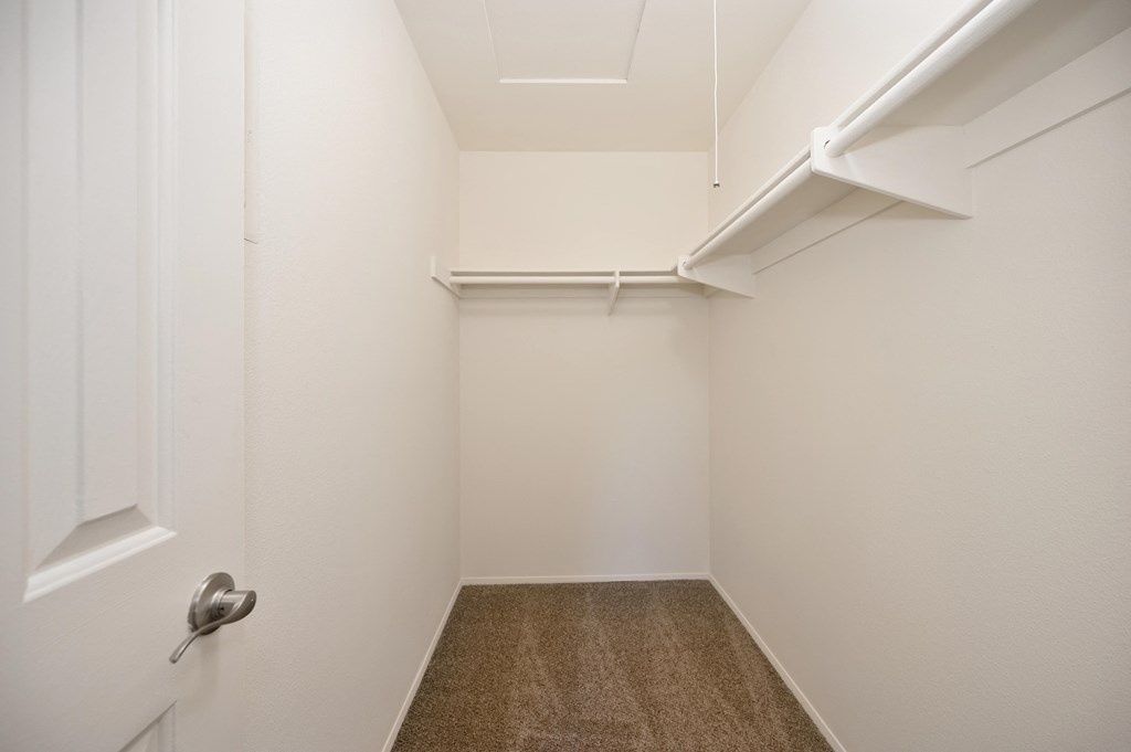 an empty room with white walls and a white closet