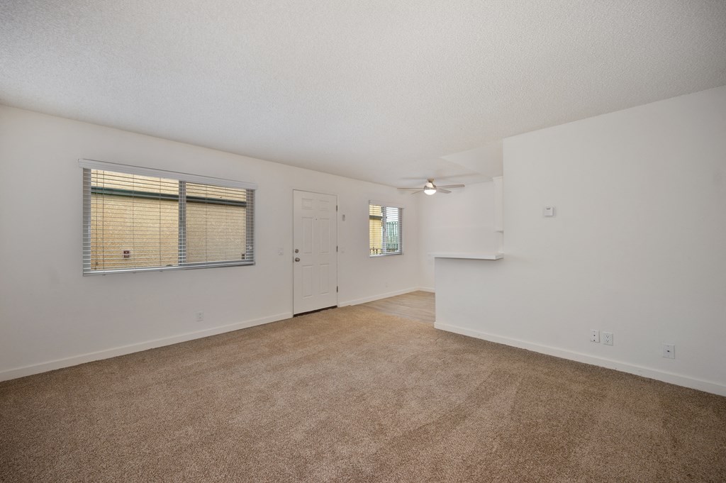 the living room and dining room of an apartment