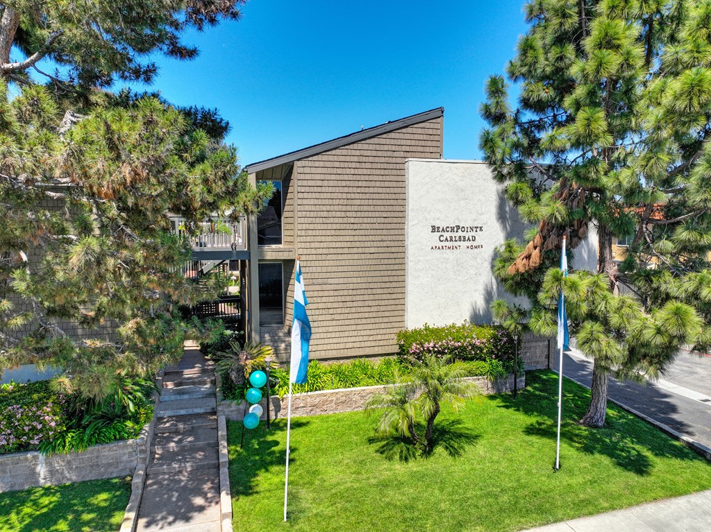 a building with flags and trees in front of it