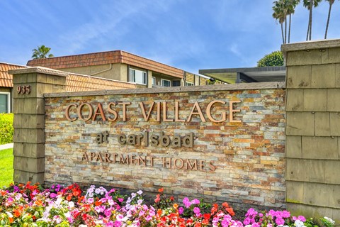 a sign for the coast village apartment homes