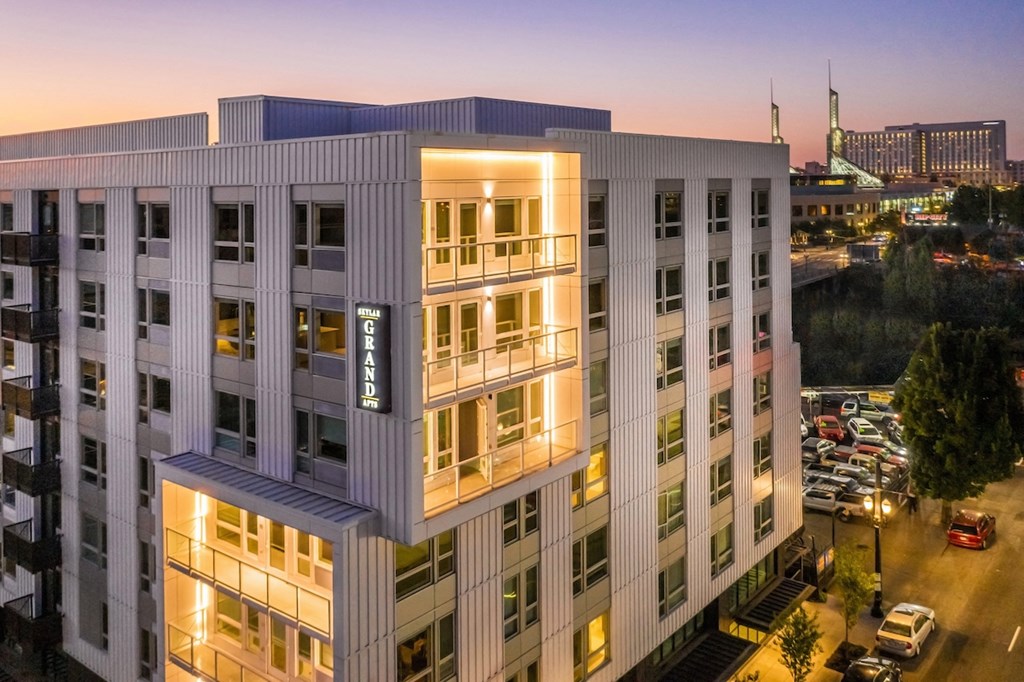 Dusk view of Skylar Grand community exterior and lighted balconies