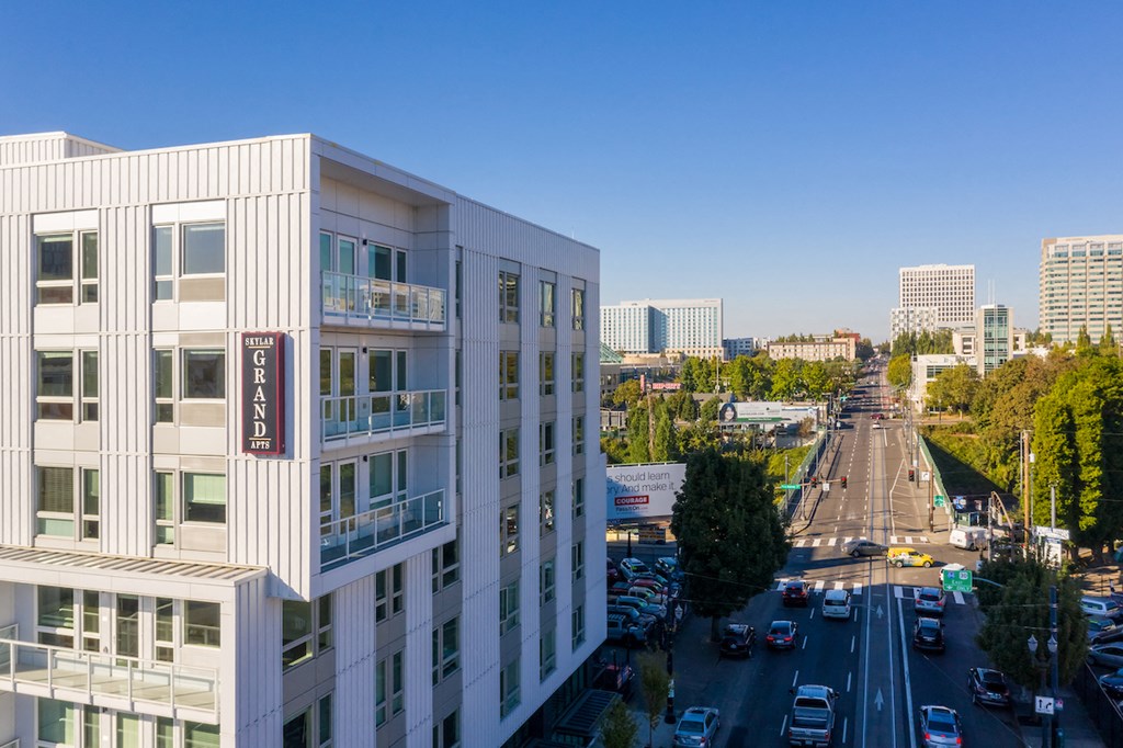 Skylar Grand building exterior with monument sign and down street view