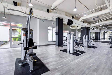 A gym with a variety of equipment including a leg press machine.