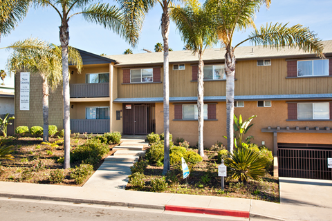 Exterior of Elan Sealofts Apartment building with the controlled access entrance to the parking garage.