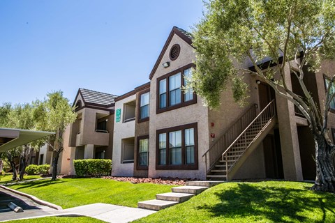 Community exterior with windows, staircase, and beautiful green lawn.