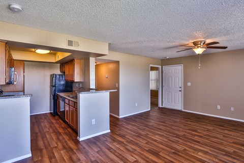 A kitchen with a refrigerator, microwave, and oven.