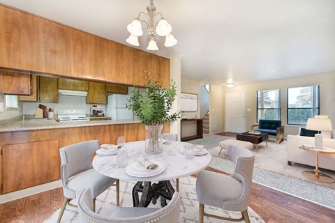 A dining room with a white table and chairs.
