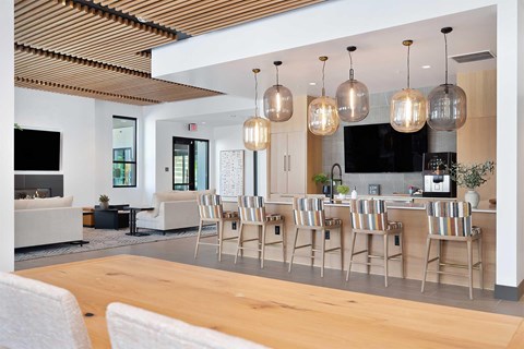 A modern kitchen with a dining table and chairs.
