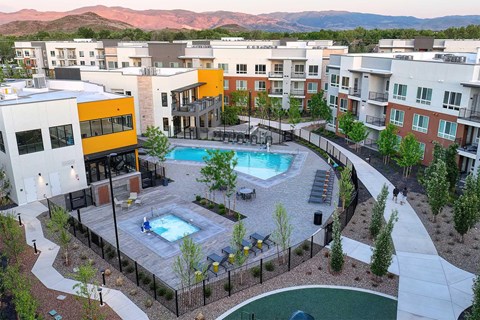 A pool surrounded by a fence and a building.