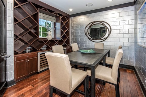 A dining room with a wooden table and chairs.