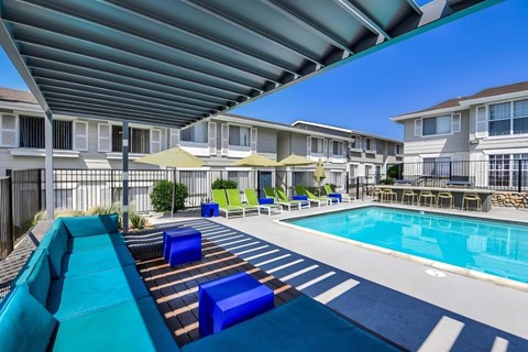 A pool area with a lounging area.