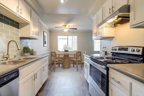 A modern kitchen with a dining table and chairs.