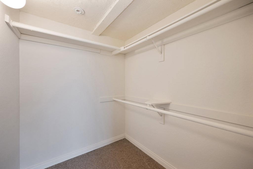 an empty room with white walls and white rails on the wall