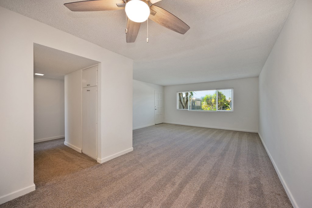 an attic bedroom with a bed and a ceiling fan