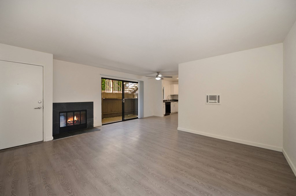 a living room with a fireplace and a hard wood floor