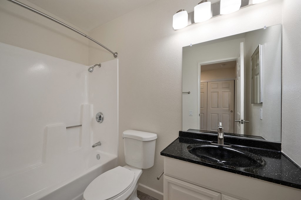 a bathroom with a sink toilet and a shower