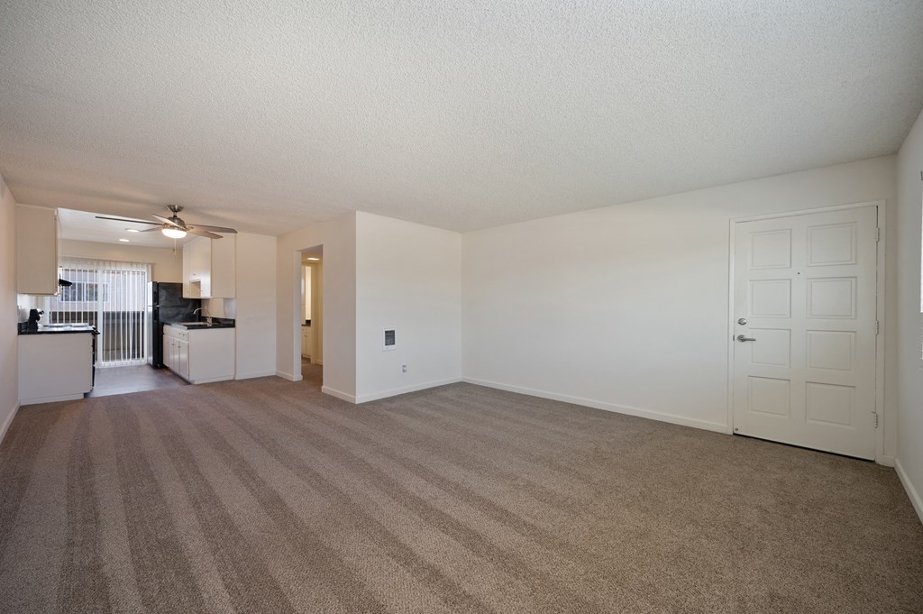 the living room and kitchen of an apartment