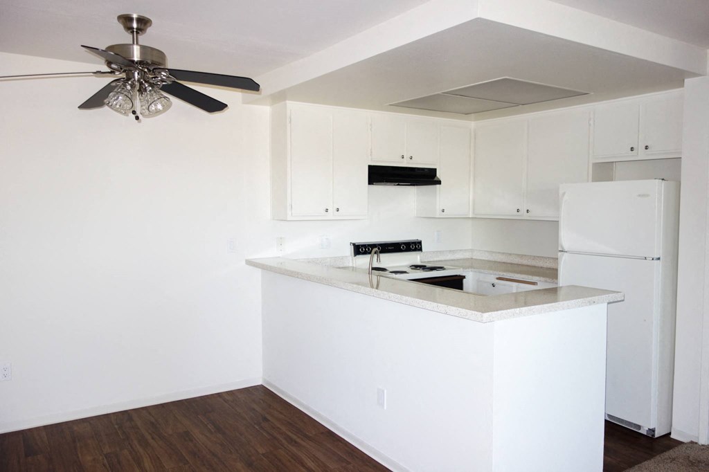 a kitchen with white cabinets and a white counter top
