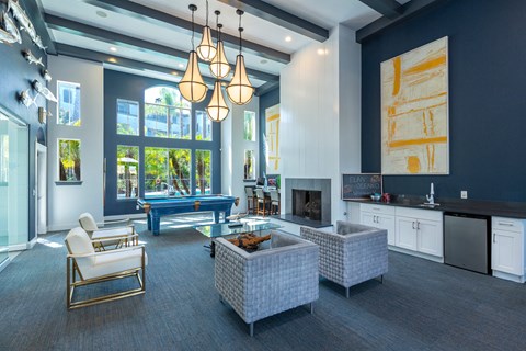 a large living room with blue walls and a pool table