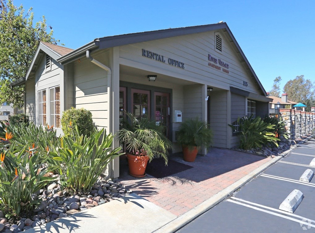 the front of the royal opera building with potted plants outside