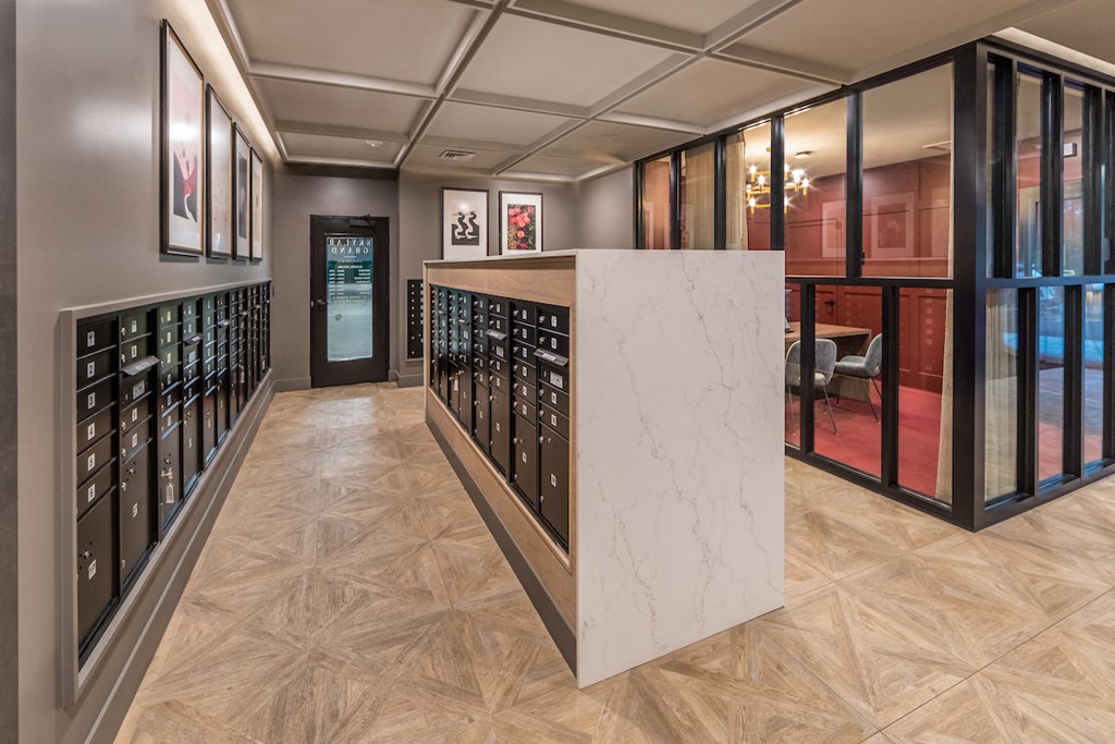 Skylar Grand mailroom with view to glass enclosed leasing office.