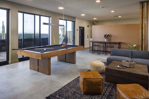 A room with a pool table and a couch.