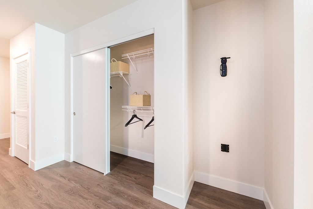 Entryway closet and single bike rack with wood style flooring