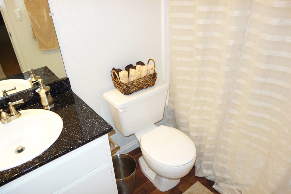 a bathroom with a white toilet next to a sink