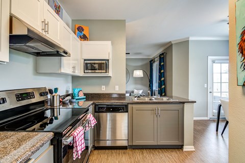 a kitchen with stainless steel appliances and granite counter tops