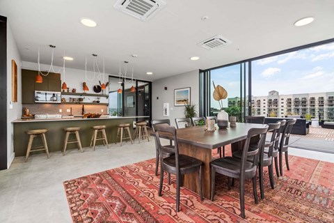 A modern dining room with a large table and chairs.