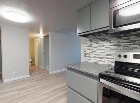 A kitchen with a stove top oven and a microwave.