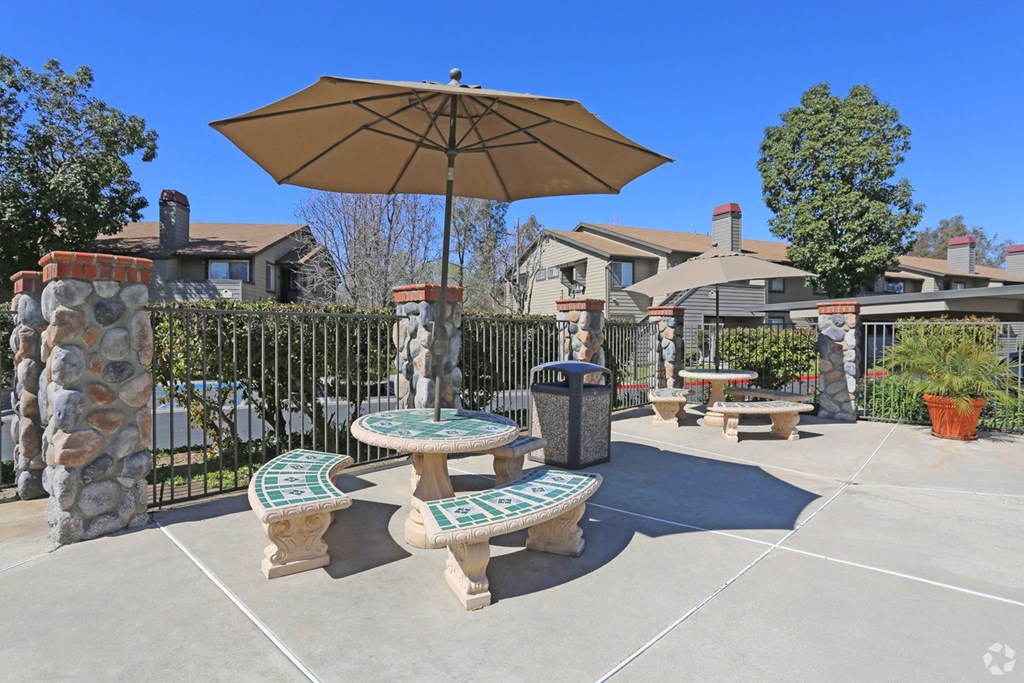 our patio has seating and an umbrella