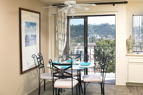 A dining room with a table set for four and a view of the valley.