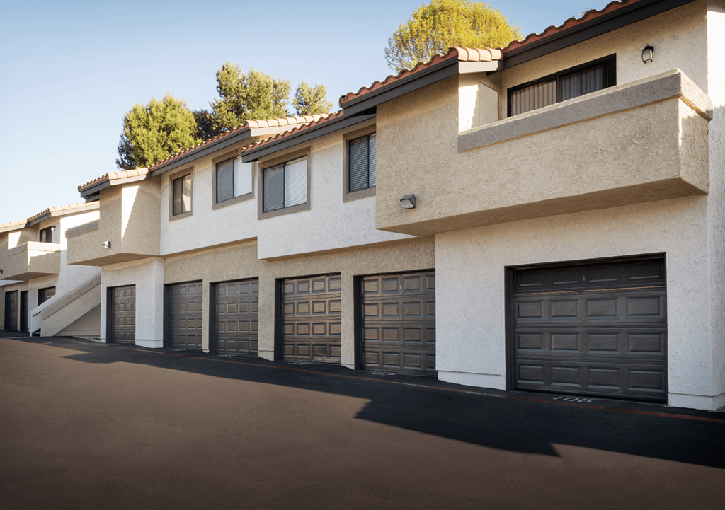 a row of houses with garage doors