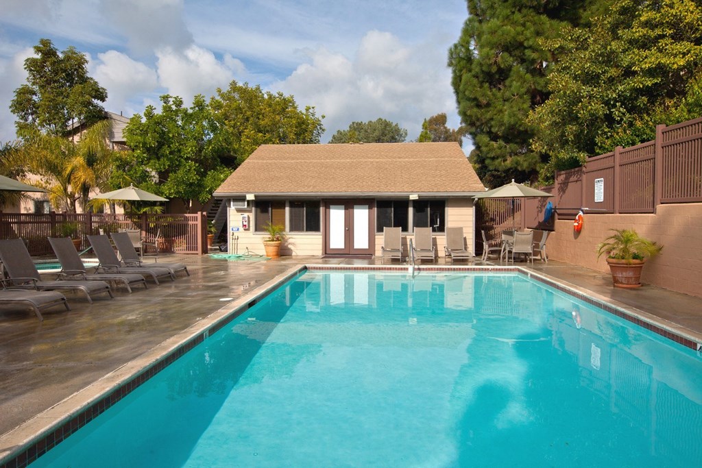 a swimming pool with a house in the background