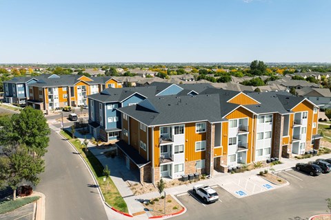 A row of modern apartments with orange and blue accents.