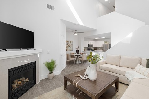 A modern living room with a fireplace and a television.