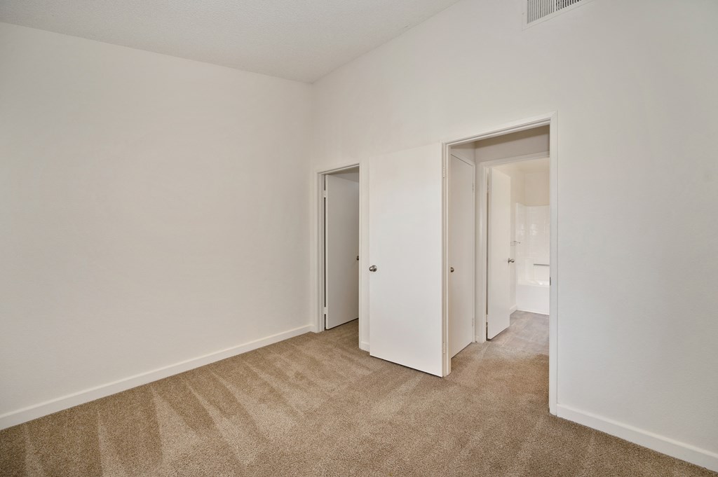 Bedroom with high vaulted ceiling