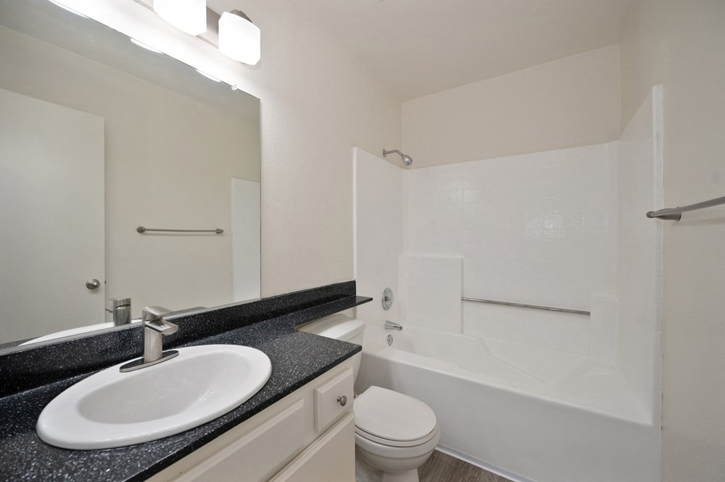 Bathroom with black countertops