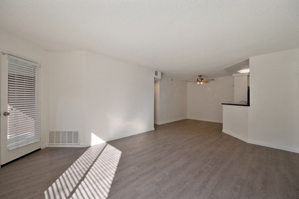 Apartment living and dining areas with hardwood floors