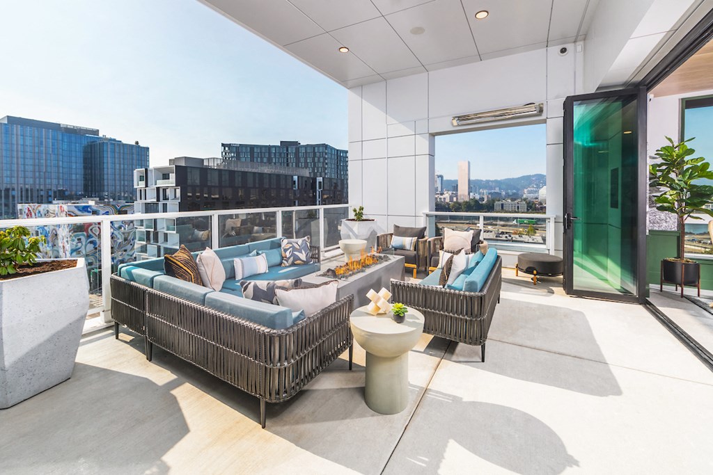 Rooftop lounge with outdoor couches and views of Portland, Oregon
