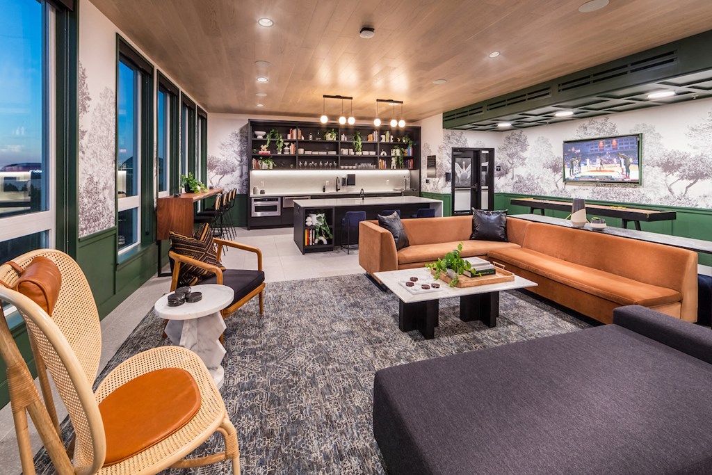 Skylar Grand social lounge with couches, chairs, tables, and kitchenette
