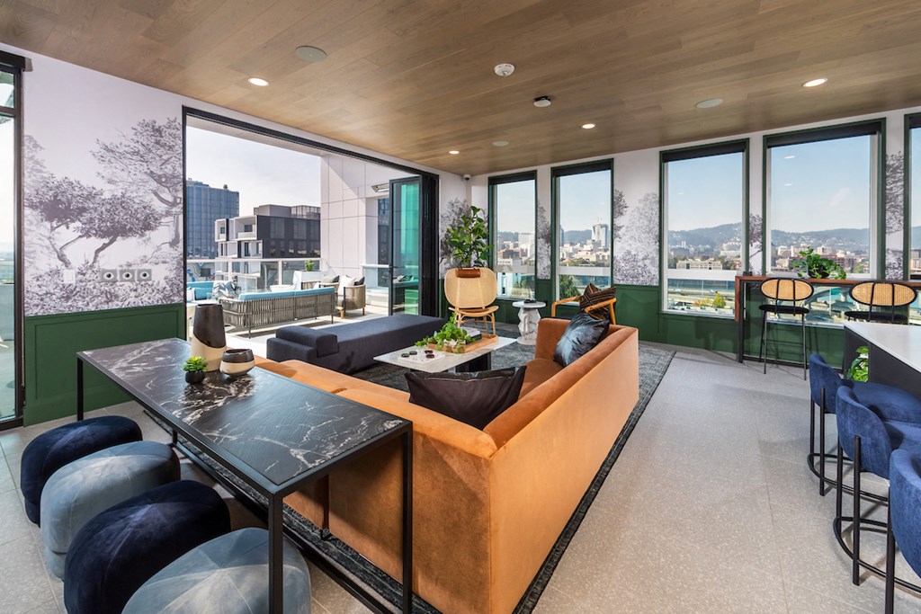 Social lounge and terrace with couch, tables, and entry to rooftop terrace