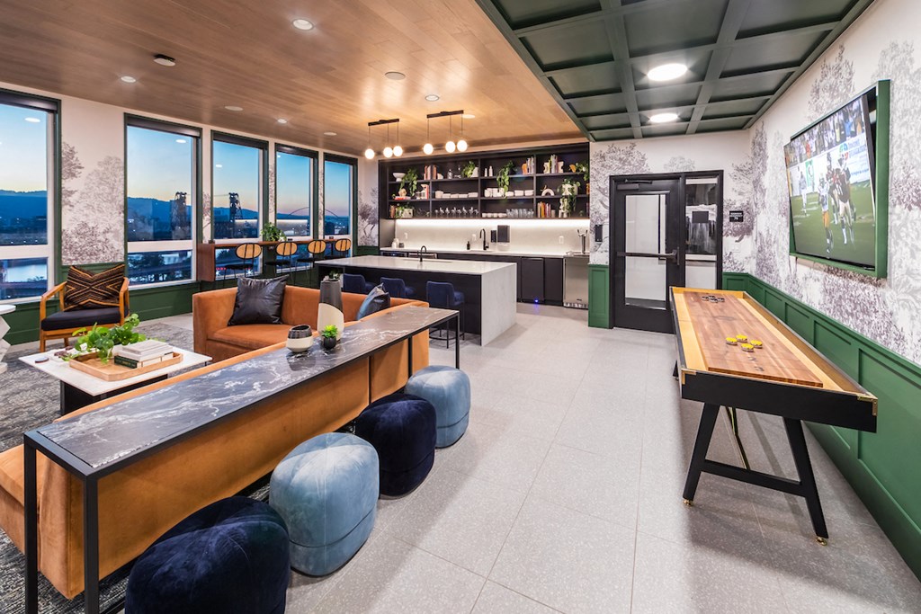 Social lounge with tabletop shuffleboard, lounge, and kitchen